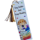 Bookmark with an illustration of a stack of rainbow books with a golden retriever leaning on top, text saying Stay Golden And Keep Reading, rainbow stars on the background. The image has a plain white background. 
