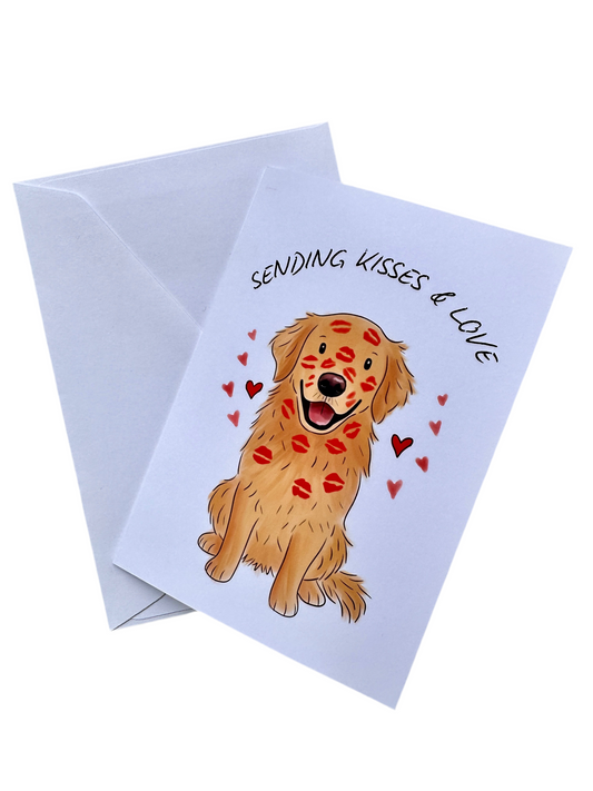 Image of a greeting card with envelope. Card includes illustration of a golden retriever covered in red lipstick kisses surrounded by red hearts. The background is white and the text across the top says SENDING KISSES & LOVE 
