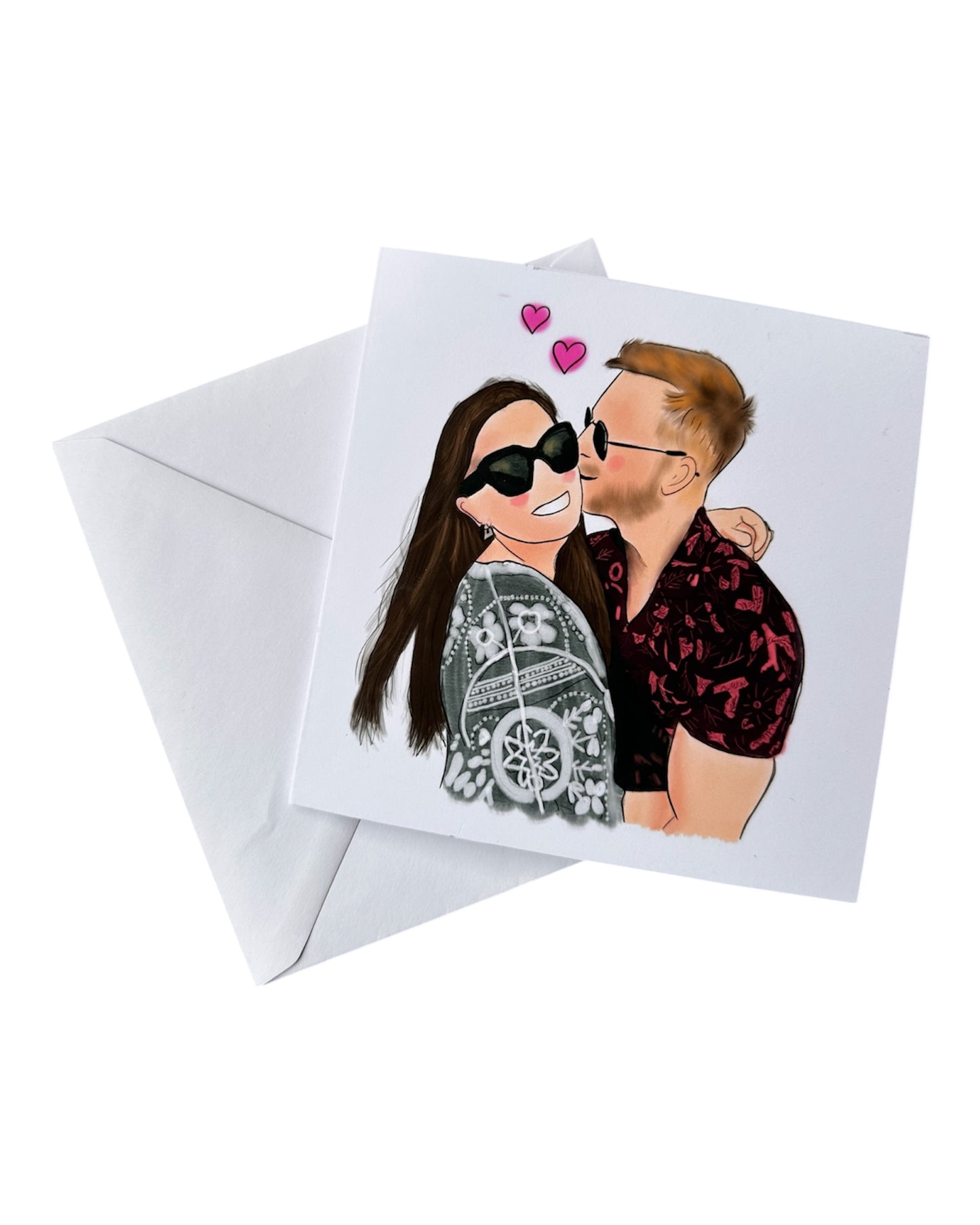 Square illustration card plus envelope of a couple hugging. Woman has long brown hair, sunglasses, big smile and black/white top. Man has blonde hair, black red top and is kissing her cheek. There are 2 pink love hearts in the background. 