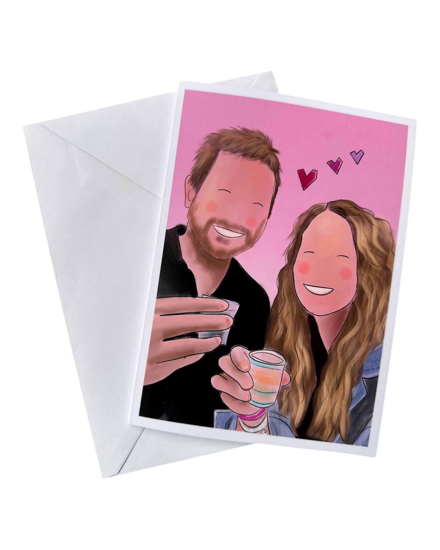 Illustration card plus envelope of a couple looking happy together holding shots of drinks. Man has a beard and a black shirt, woman has long blond hair and denim jacket. There’s 3 pink love hearts and a pink background and think white border. 